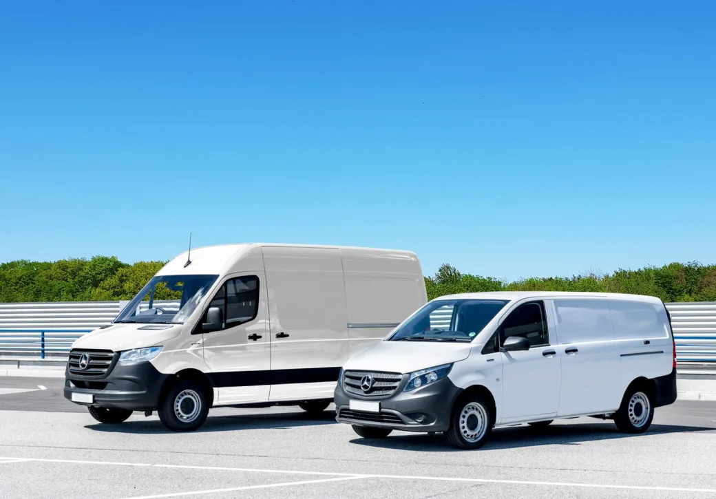 A large cargo van and a smaller compact van parked side by side