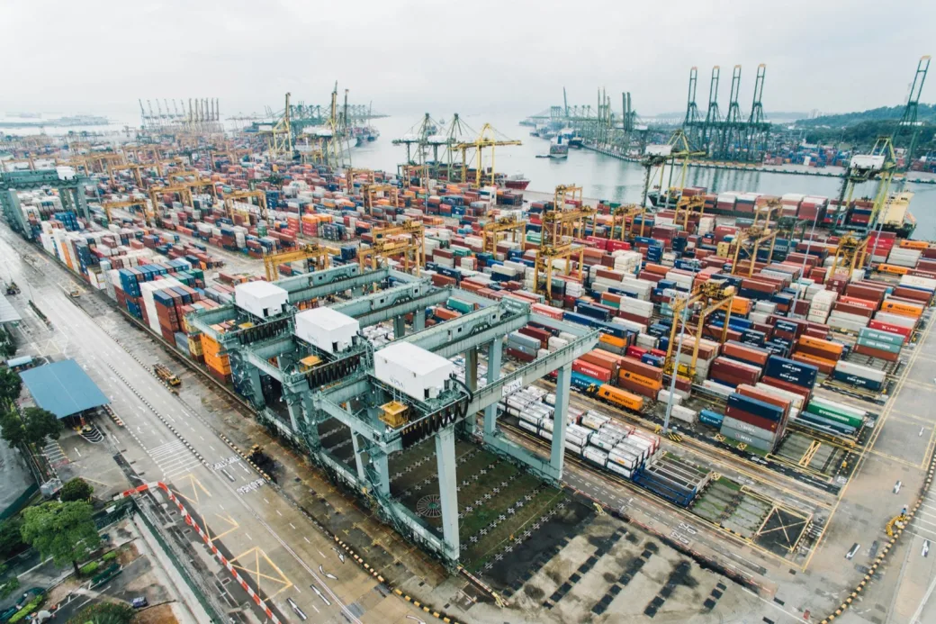 Aerial view of a container port with stacked shipping containers